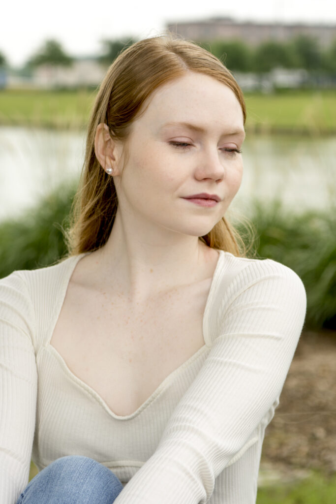 Portrait of beautiful woman with a pond in the background