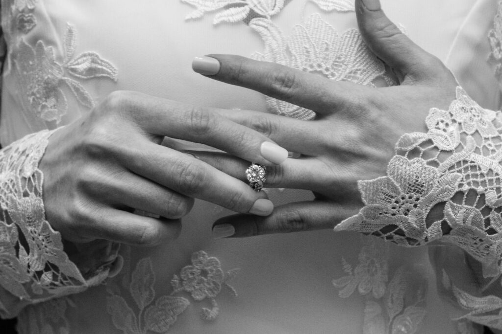 Close up shot of a bride with her engagement ring, in black and white